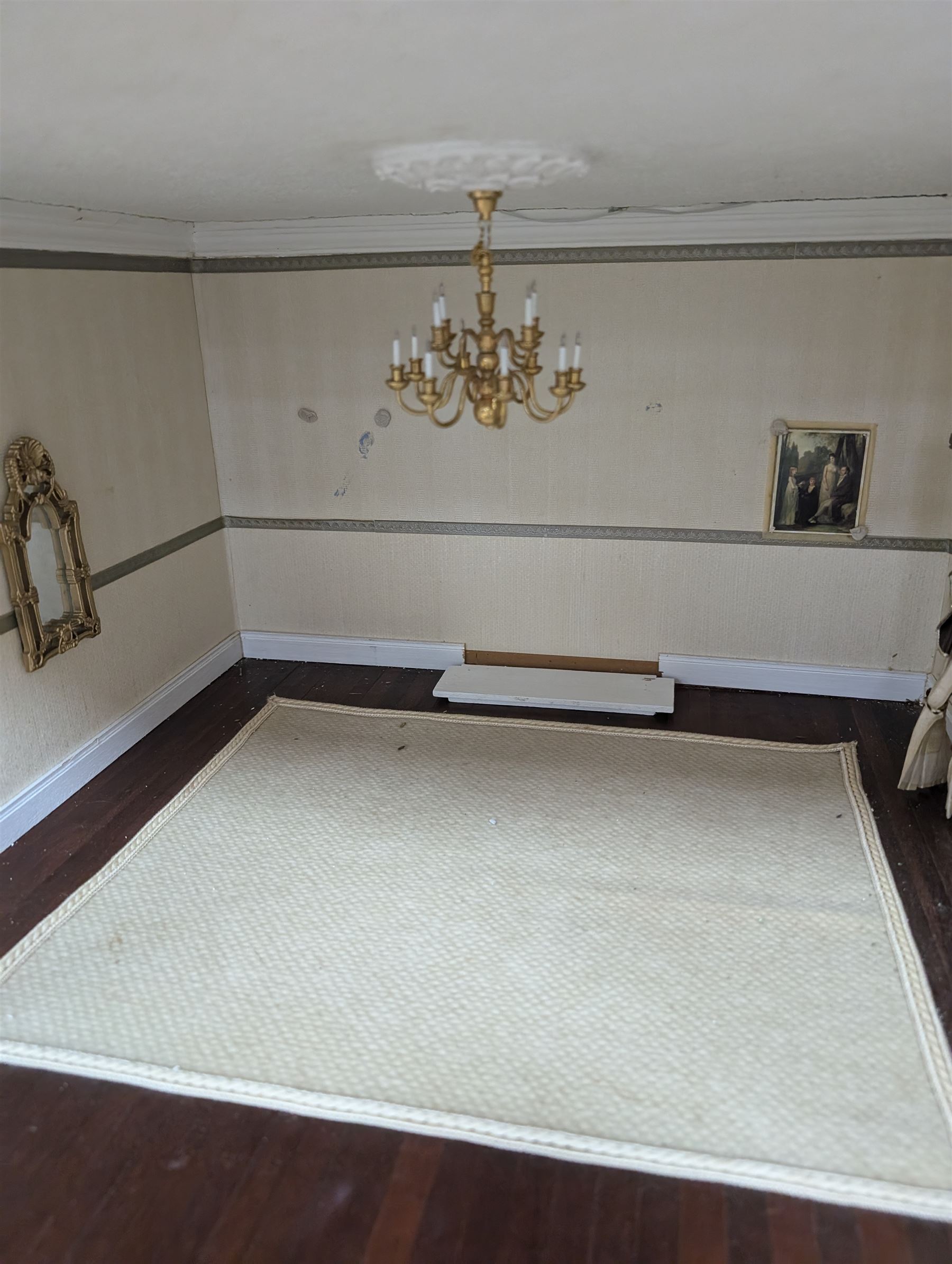 Two modern three storey dolls houses, each painted green with decorated interiors, both upon a single white wooden base, together with a large collection of dolls house furniture, accessories and figures 