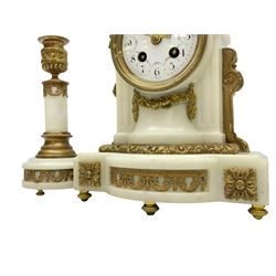 An early 20th century white marble mantle clock in a break front case with an arched top and finial, gilded scroll work to the sides and pierced foliate panels to the front, plinth raised on five bun feet, enamel dial with garland decoration, Arabic numerals, minute markers and Louis XV gilt hands, within a convex glazed bezel, eight-day Parisian striking movement striking the hours and half hours on a bell, with two conforming single light candlesticks. With Pendulum.

