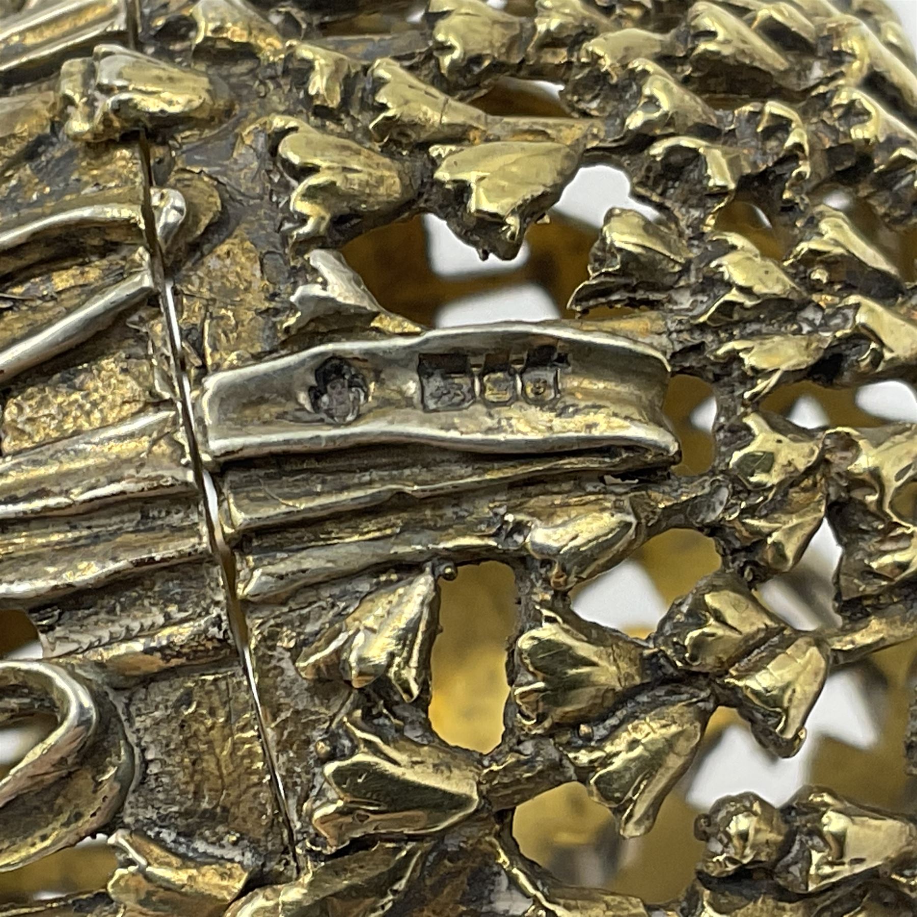 Modern silver limited edition Easter egg, no. 70/500, the gilt openwork body decorated with cascading bluebells and hinged cover with pierced circular panel set with a single faceted purple stone, opening to reveal a gilt interior, upon silver stand with three scrolling pad feet, each hallmarked St James House Company, London 1981, height including stand 8cm