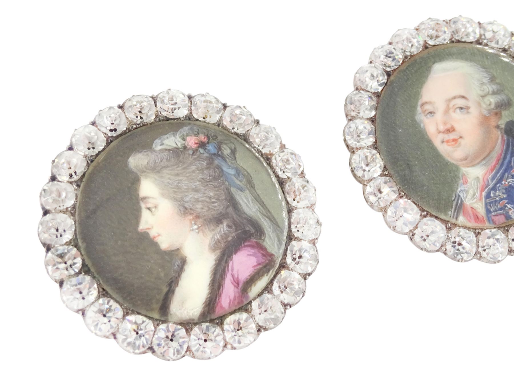 Set of six late 18th century French portrait miniature buttons, each finely painted upon ivory with a likeness of notable figures of the French Royal Court, set under glazed panels within silver frames mounted with paste stones, engraved verso with the sitters’ names and fitted with eyelets, later adapted with suspension rings; comprising “LE ROY” (Louis XVI), “LA REINE” (Marie Antoinette, youth portrait), “LA REINE” (Marie Antoinette, mature portrait), “MADAME” (Maria Josepha of Savoy, 1771–1810, wife of Louis, Comte de Provence, later King Louis XVIII), “M. BAILLY” (Jean Sylvain Bailly, 1736–1793, Mayor of Paris), and “M. L’ABBÉ MAURY” (Jean-Siffrein Maury, 1746–1817, Cardinal and Archbishop of Paris), overall D3.5cm. This lot has been registered for sale under Section 10 of the APHA Ivory Act