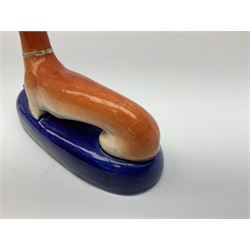 Pair of Staffordshire recumbent greyhound pen holders 