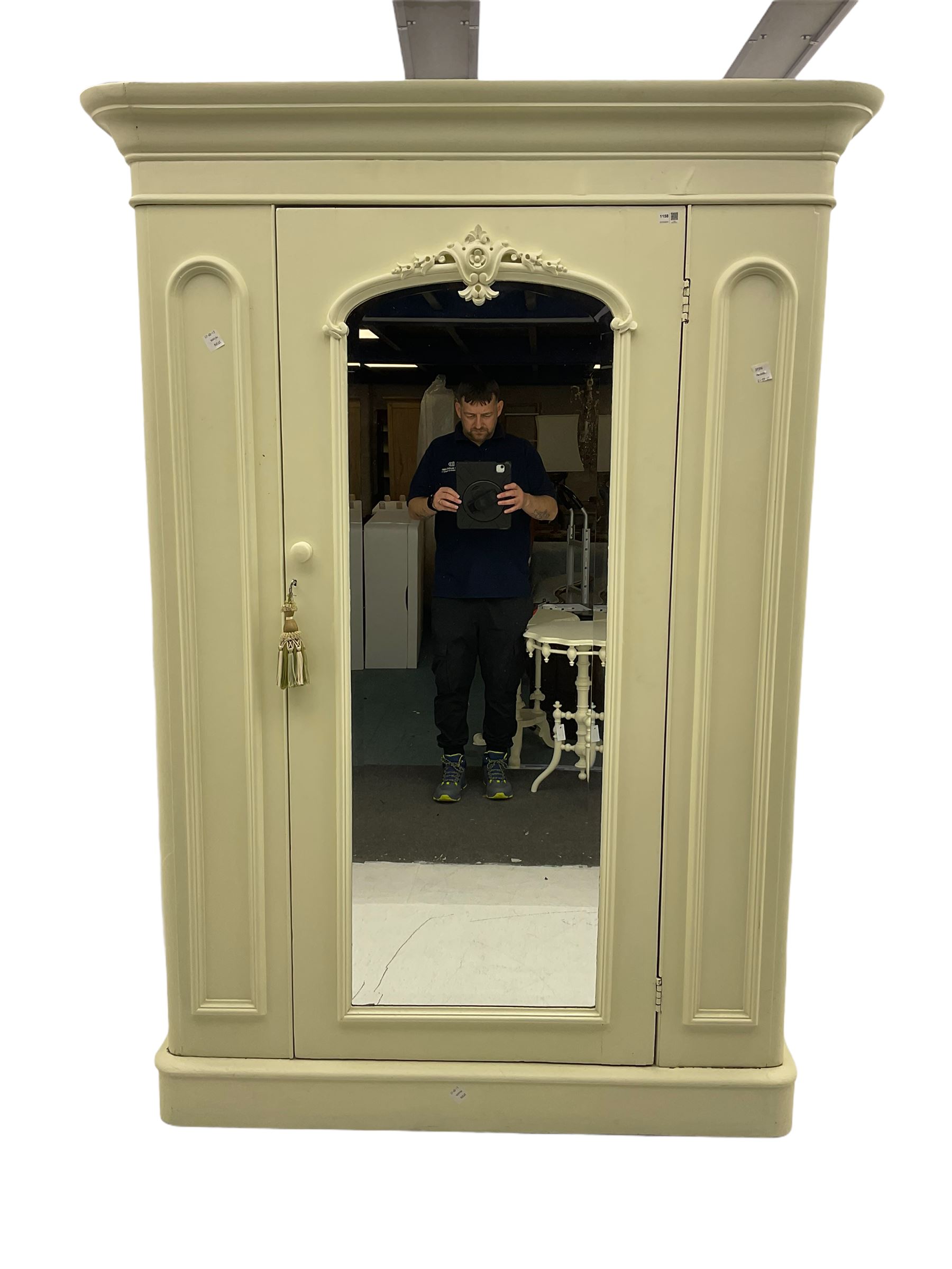 Victorian white painted wardrobe, the projecting cornice over centre mirror glazed door, the interior fitted with drawer and two hinged compartments, plinth base