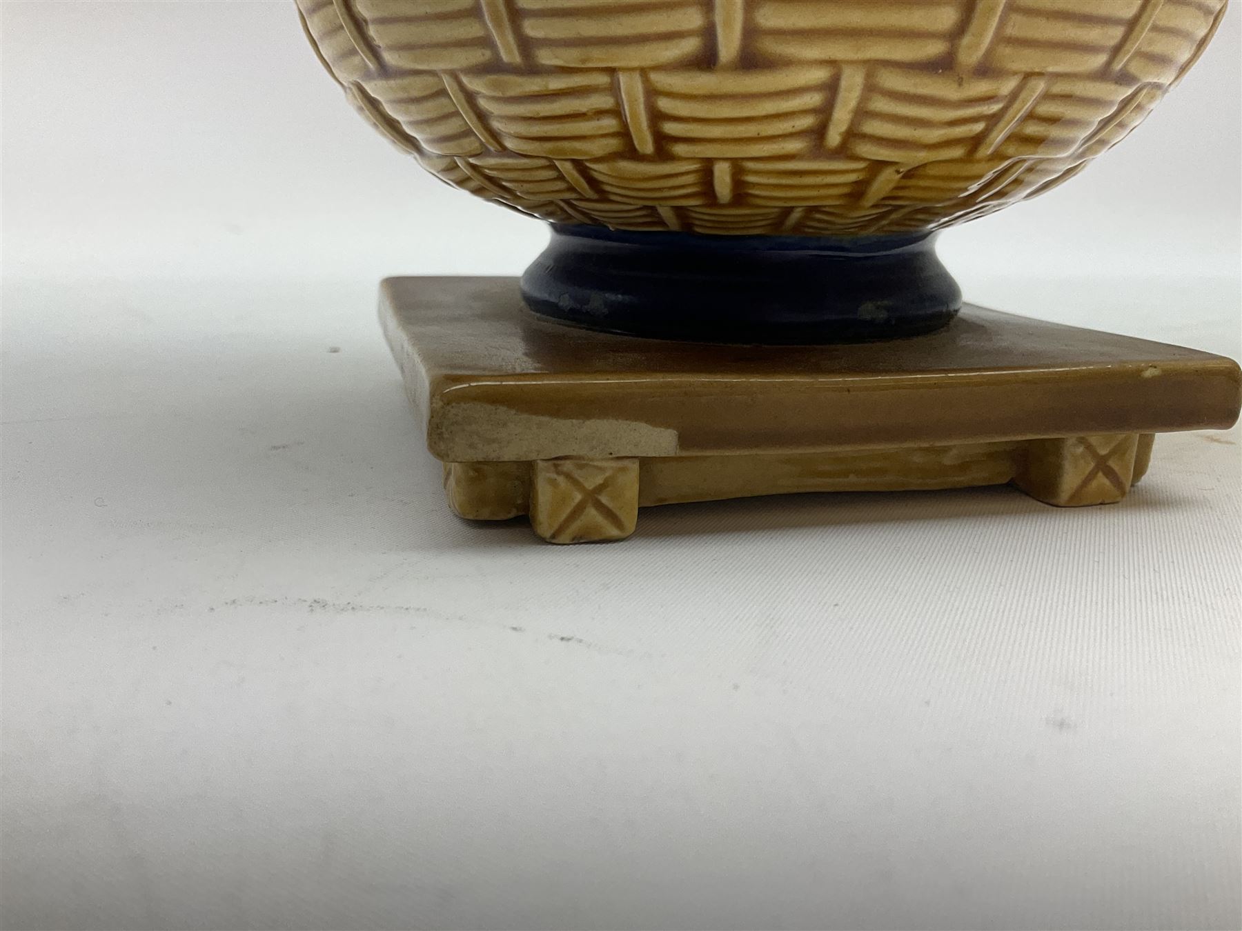 Minton majolica vase, the squat body with twin handles, with part osier moulding and applied Spring flowers against a cobalt blue ground, upon integral square base, impressed beneath Minton 1316, H16.5cm