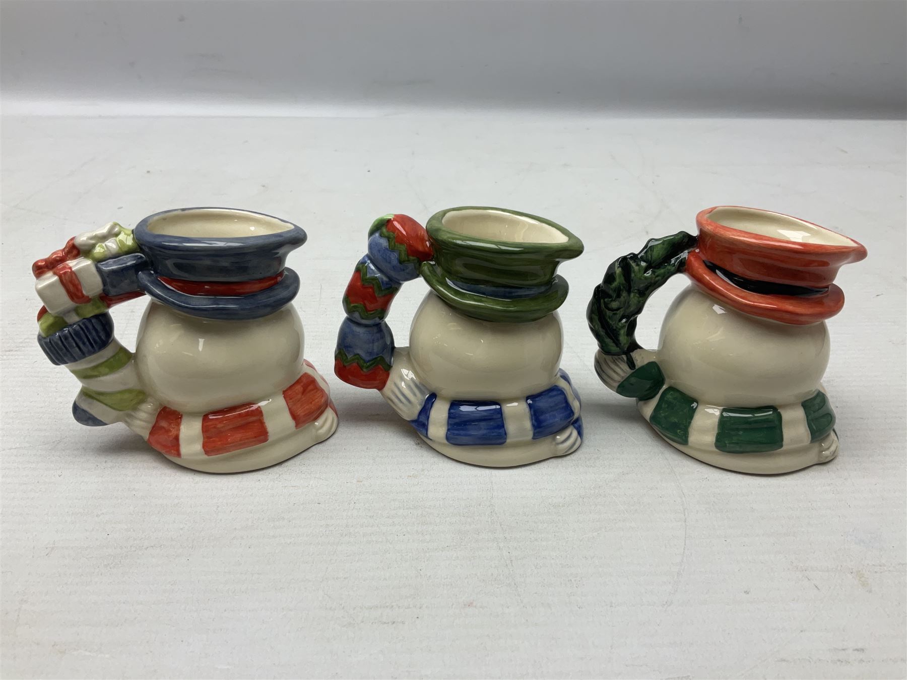 Three Royal Doulton The Mickey Mouse Collection figurines comprising Mickey Mouse MM1, Minnie Mouse MM2, and Goofy MM5, together withe three Royal Doulton limited edition miniature snowman character jugs comprising Christmas Stocking Snowman D7124, Christmas Cracker Snowman D7158 and Snowman D7062, all with original boxes 