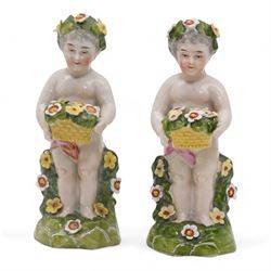 Early 20th century French porcelain tray, hand painted with dancing cherubs, within a pink and gilt border, inscribed 476 beneath, L25.5cm, pair of continental cherub figures, with blue anchor marks beneath, together with a Dresden porcelain pot pourri and cover, with pierced and floral decoration (4)