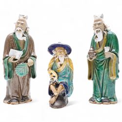 Three Chinese mud man figures, including man with fish, together with two terracotta warriors, H16cm