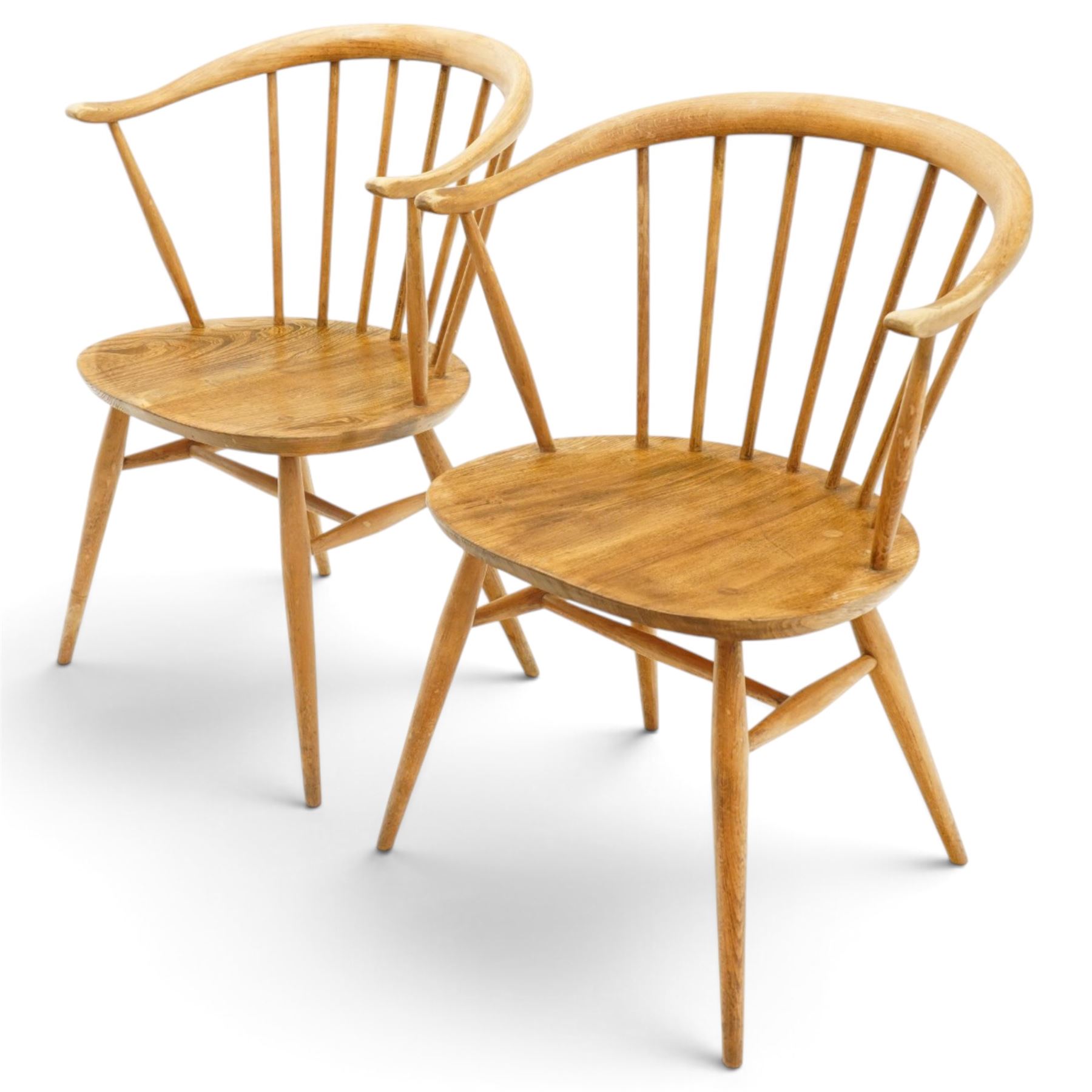 Ercol - pair of 'Cowhorn' elm carver chairs, curved back raised on nine stretchers, elm dished seats, raised on tapering supports