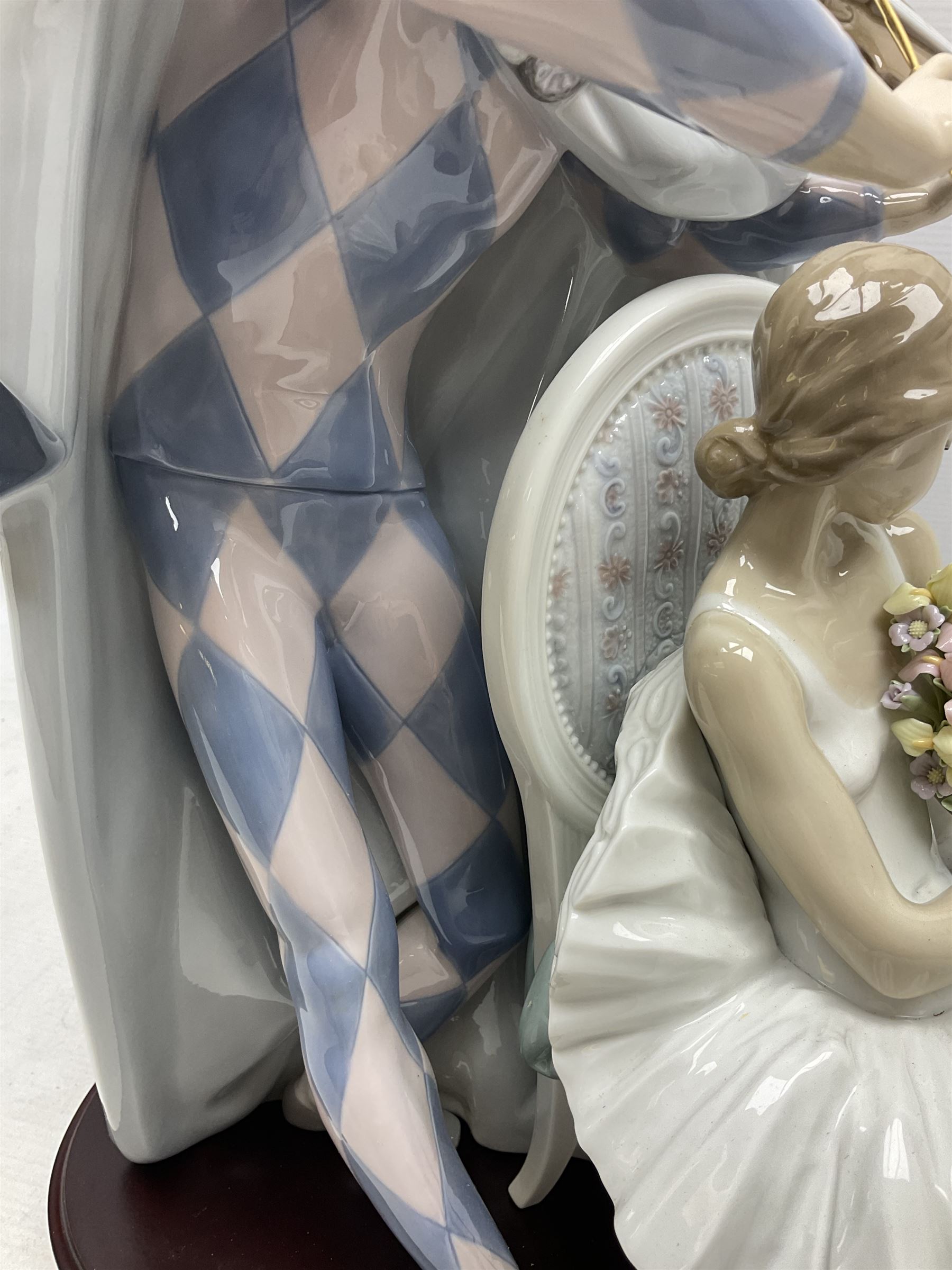 Lladro figure, Jester Serenade, modelled as a ballerina with bouquet of flowers seated before a jester playing the violin, limited edition 2541/3000, sculpted by Antonio Ramos, no 5932, with original box, year issued 1993, year retired 1994, H37cm