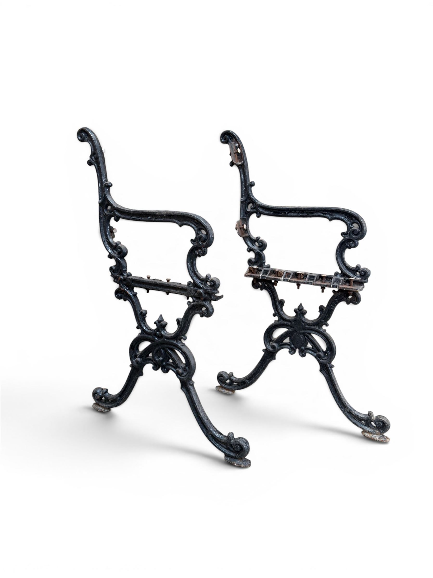 Carron Foundry - two pairs of 19th century cast iron garden bench ends, ornate detail with arms and X shaped legs,finish in black paint, the design no. 110396, first registered 13 July 1857 (see illustration), width as desired