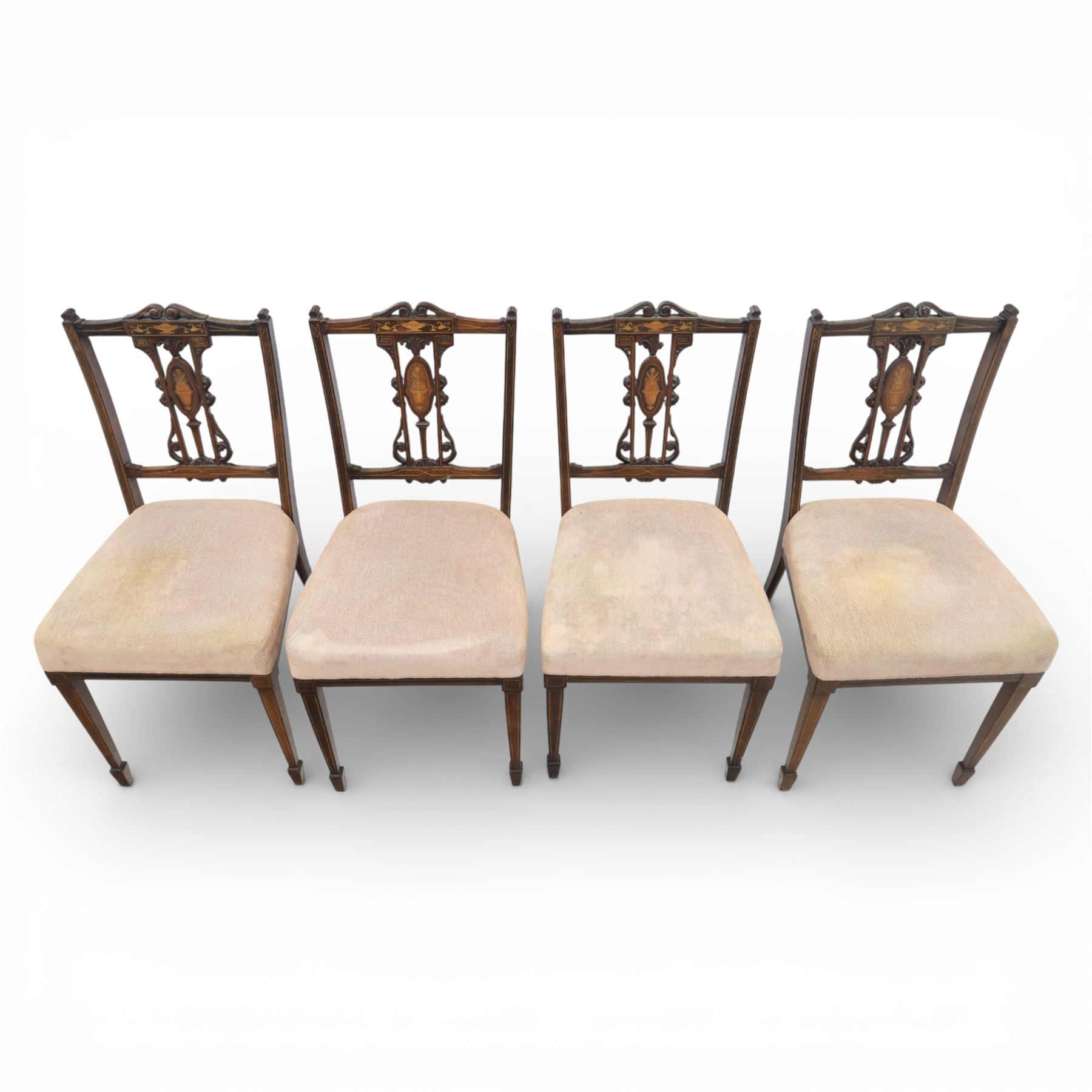 Quality Edwardian seven piece inlaid salon suite, comprising three seater settee, pair of arm chairs and four chairs with pierced splat backs, upholstered in pale pink fabric, inlaid with flowering urns, upon tapering legs with spade feet and castors