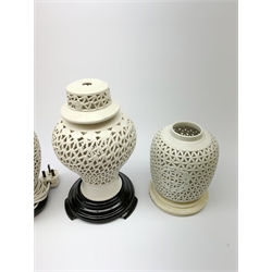 Four Chinese reticulated or pierced white glazed lamp bases, (two without fittings), largest H30cm. 