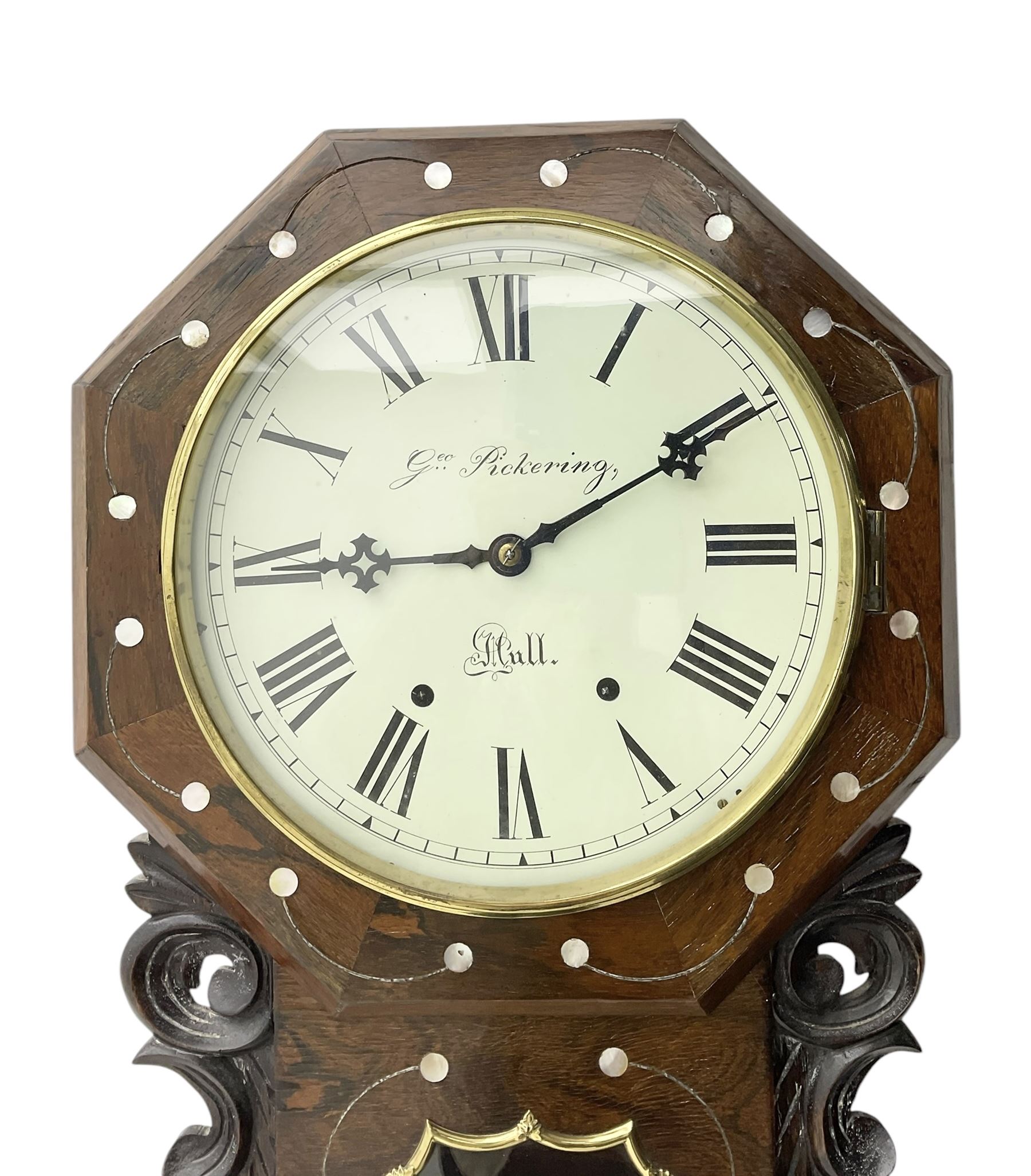 George Pickering of Hull - 8-day American mahogany and mother of pearl inlaid drop dial wall clock c 1880, with an octagonal dial surround and spun brass bezel, painted dial with Roman numerals, minute track, retailers name and Maltese cross hands, case with an ogee base, carved ears and pendulum viewing glass, twin train spring driven movement striking the hours on a bell.  With key and pendulum.