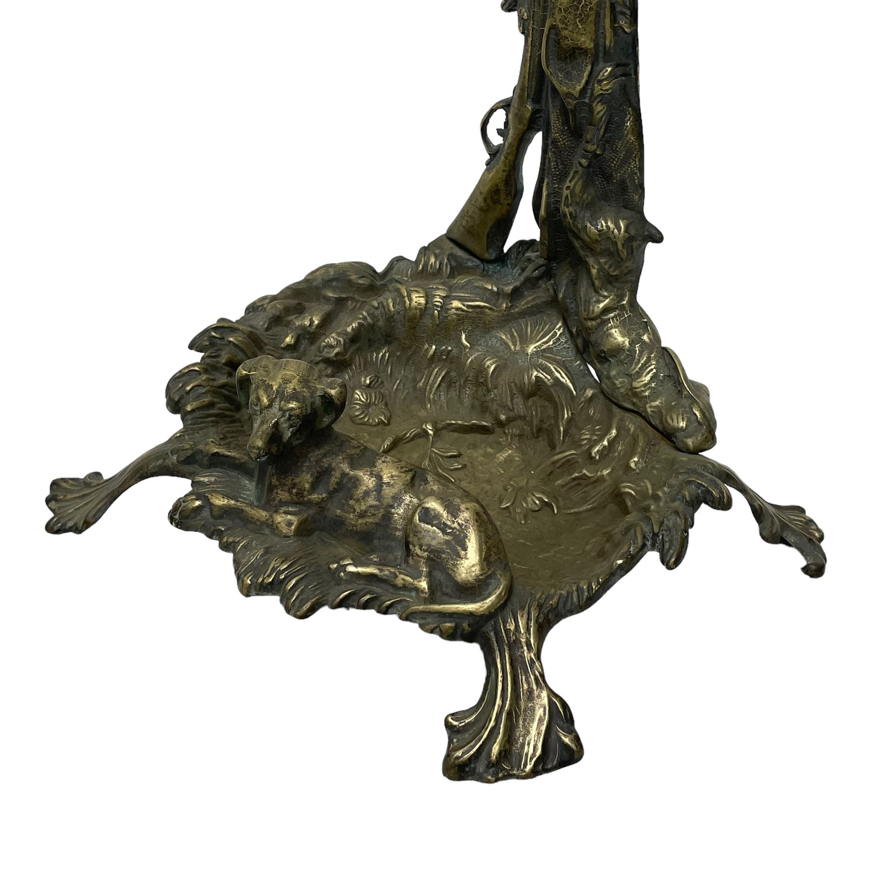 Pair of cast brass hallway umbrella or stick stands, in the form of a tree decorated with trailing flowering foliage branches, the stem with hunting horn over leaning shotgun, shaped naturalist tray base with hunting hound and out splayed foliate cast feet 