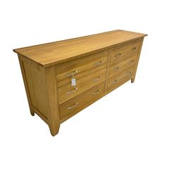 Contemporary wide oak straight-front chest, fitted with a bank of six drawers with chrome handles, on tapered feet