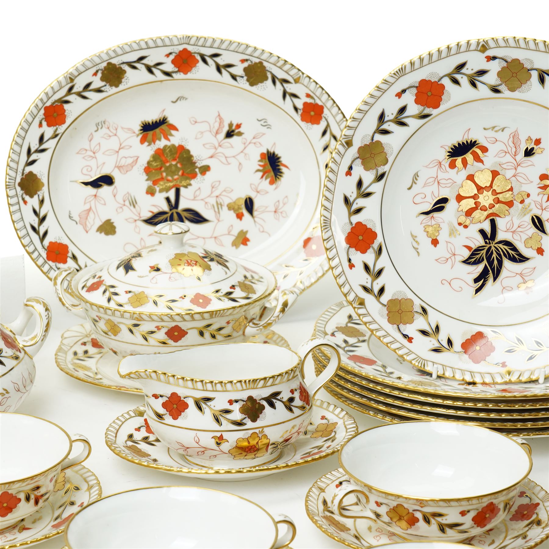 Royal Crown Derby Asian Rose pattern dinner service for twelve covers comprising  twelve dinner plates, twelve dessert plates, twelve two handled soup bowls and stands, pair of sauce boats and stands, pair of sauce tureens with covers and stands, pair of vegetable dishes and covers and two graduated meat plates, date code 1974