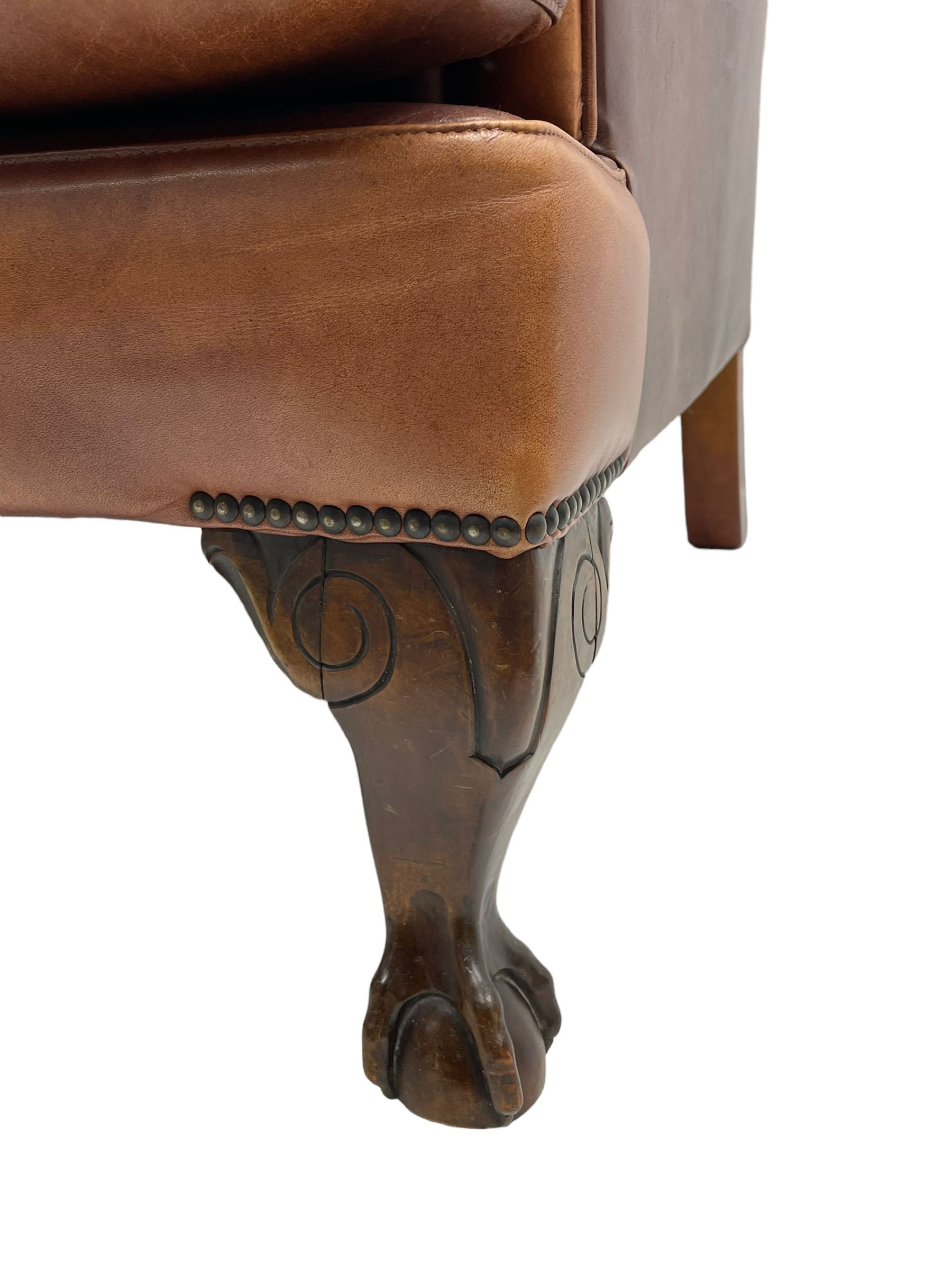 Tetrad - 'Blake' club armchair, fanned wingback and rolled arms upholstered in tan brown leather, on ball and claw carved cabriole feet 