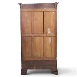 Edwardian walnut double wardrobe, featuring two mirrored doors with bevelled plates, carved frieze with fluted pilasters, above single base drawer