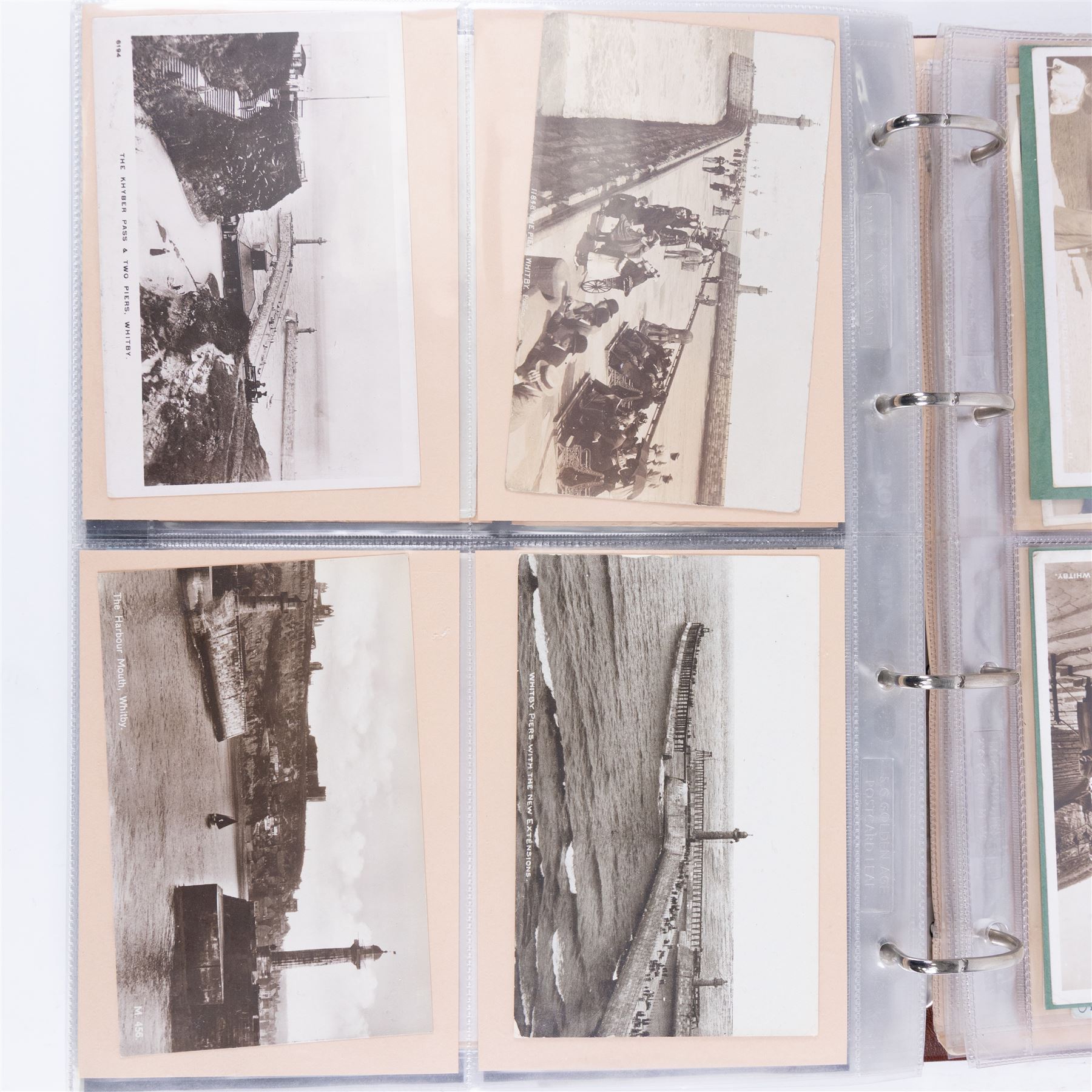 Two-hundred and thirty eight early 19th century to 20th century Whitby view postcards, including twenty-four early 19th century court cards, seventeen views of Whitby Abbey, forty depicting the fishing fleet and harbour, with a selection of cards providing a detailed study of the early 'Yards' the fisherman's dwellings around the harbour, all housed within a Stanley Gibbons Picture Postcard Album