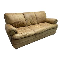 Large three-seat sofa upholstered in stitched brown leather with stud work decoration, rolled back and arms