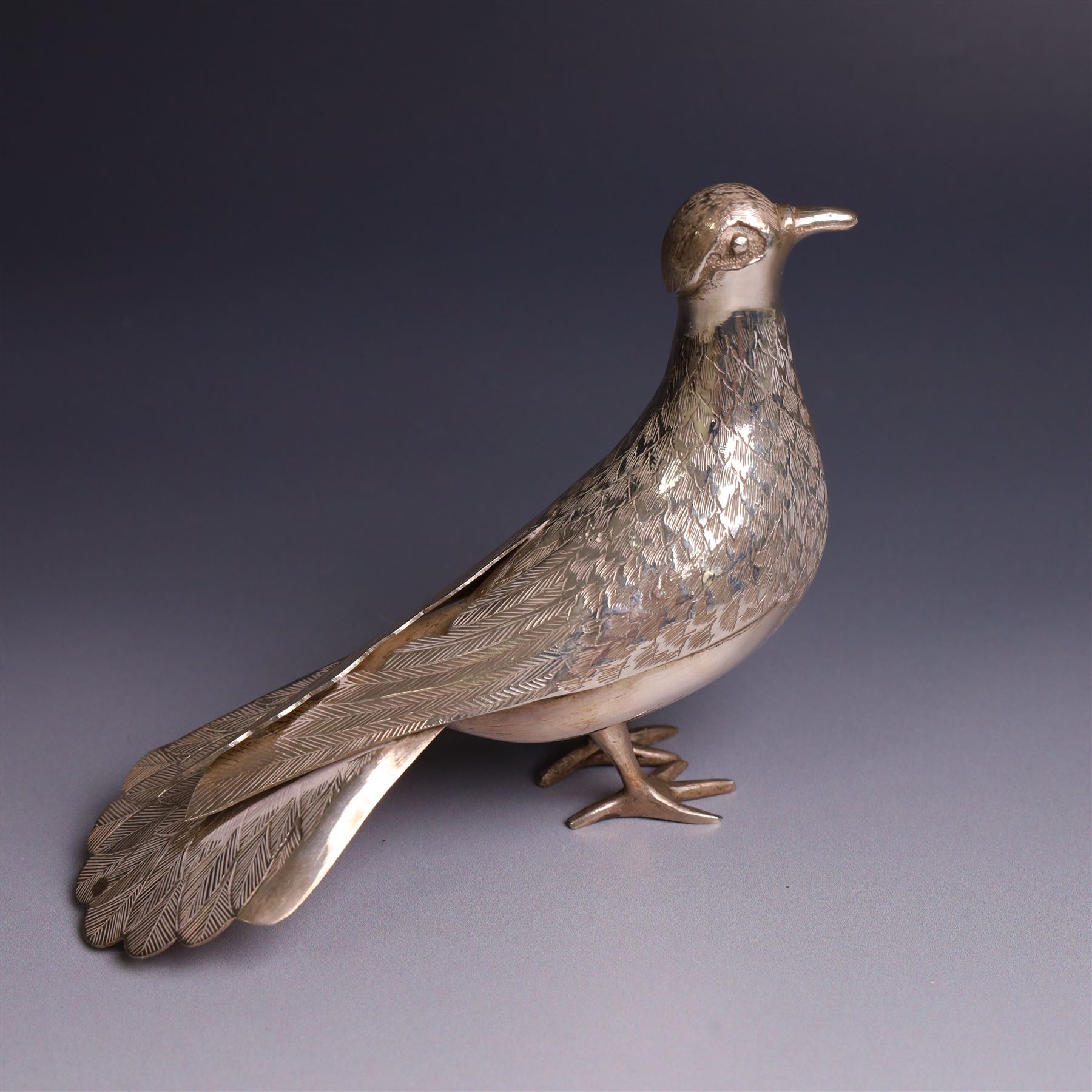 Mid 20th century Iranian silver model of bird, with engraved feathers, stamped with lion with scimitar to underside of tail, H11cm