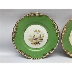 Set of four early 19th century plates, hand painted with birds within green and gilt ornate border D24cm