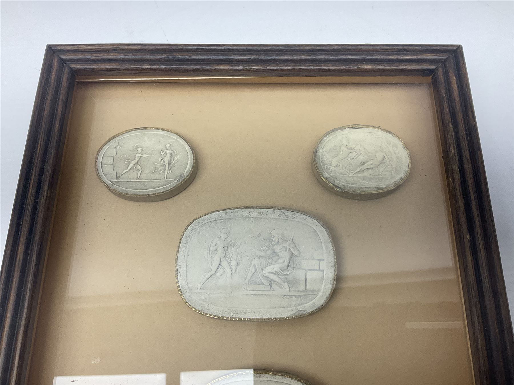 Set of six 19th century Grand Tour plaster intaglios, each depicting classical figures, frame H25cm, W19cm