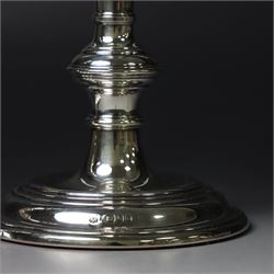 Pair of silver candlesticks, with knopped stems and upon spreading circular weighted bases, hallmarked William Comyns & Sons Ltd, London 1979, H20cm