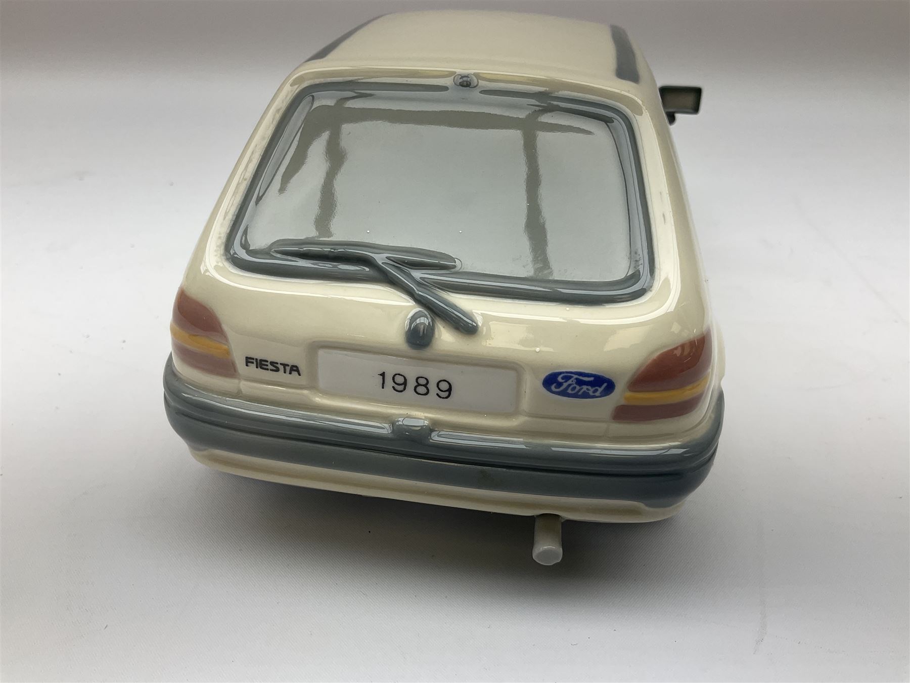 Lladro figure, Ford Fiesta, modelled as a Ford in beige, special commission by the Ford factory in Valencia, original box, no 7608, year issued 1989, year retired 1989, H9cm 