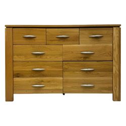 Contemporary light oak sideboard, rectangular top over three short and six long drawers each fitted with chrome handles, on plinth base