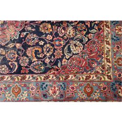 Vintage Persian Tabriz indigo ground rug, the central floral medallion within a field woven with scrolling palmettes and plant motifs, with contrasting spandrels, the the cyan guard lines with scrolling floral patterns