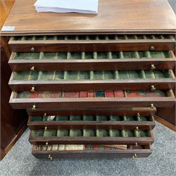 Regency ebony strung mahogany medal or coin collectors cabinet, with reeded top, two panel doors enclosing eleven drawers, shaped out splayed bracket feet
