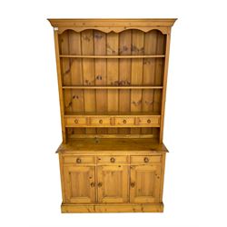 Pine kitchen dresser fitted with three tier plate rack and four spice drawers, above three drawers and cupboards 
