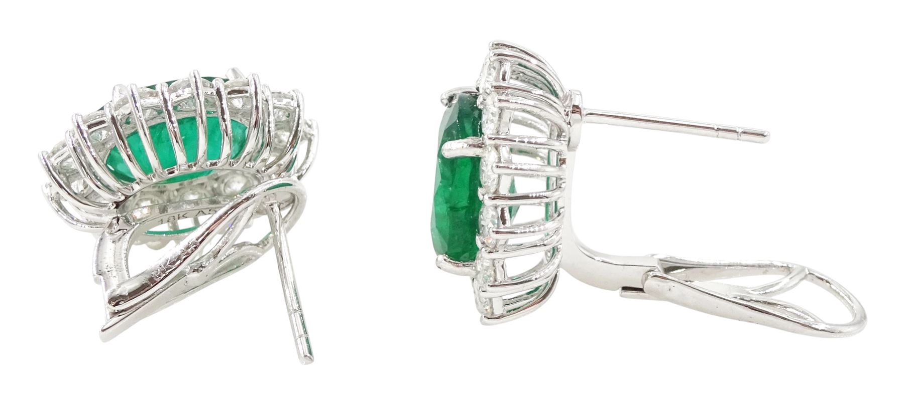 Pair of 18ct white gold emerald and diamond cluster earrings, each stud set with a single oval cut emerald, surrounded by thirteen round brilliant cut diamonds, stamped, total emerald weight approx 7.20 carat, total diamond weight approx 2.30 carat