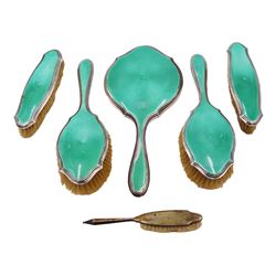 Art Deco five piece green guilloche enamel silver dressing table set, comprising hand mirror, two hair brushes and two clothes brushes hallmarked Barker Brothers Silver Ltd, Birmingham 1930, together with another silver brush, hallmarked Davis, Moss & Co, Birmingham 1928 (6)