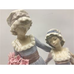 Lladro figure, Sisters, modelled as two sisters holding a basket of flowers and a floral bouquet, sculpted by Vincente Martinez, no 5013, year issued 1978, year retired 1991, H32cm  