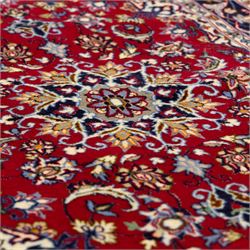 Two Central Persian rugs, ivory ground with a symmetrical foliate and floral design around a shaped cartouche medallion with a red floral and bird motif border with contrasting guard stripes, 142x76cm, Central Persian Kashan rug, crimson central field with a floral and foliate design with a stylized rosette medallion incorporating palmettes and scrolling vine work, enclosed by a dark navy border and multiple guard stripes, 117x68cm, (2)