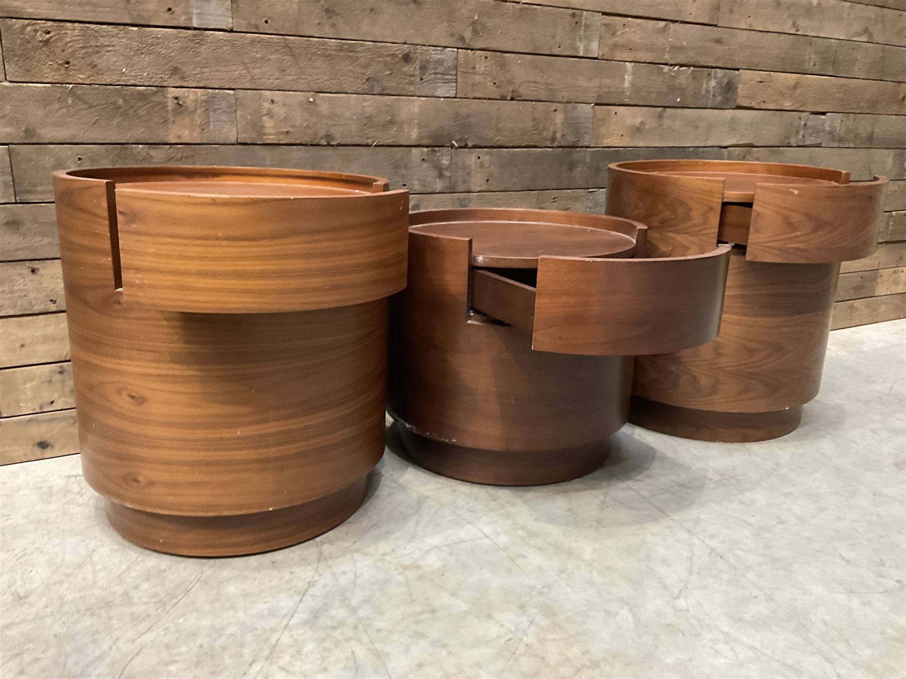 Three walnut circular barrel shaped lamp tables, fitted with single drawer (lower table D53cm, H49cm)