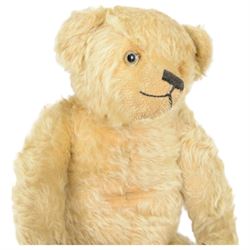 Early 20th century musical teddy bear, with golden mohair head and body, pronounced clipped muzzle, humped back, one eye, black/brown stitched nose, mouth and claws, swivel head and jointed limbs, containing pressure operated musical mechanism, L51cm

Notes by vendor repute: Previously owned by Dame Christian Howard of Castle Howard and given by her in the 1960s to the vendor who was the child of her house keeper.