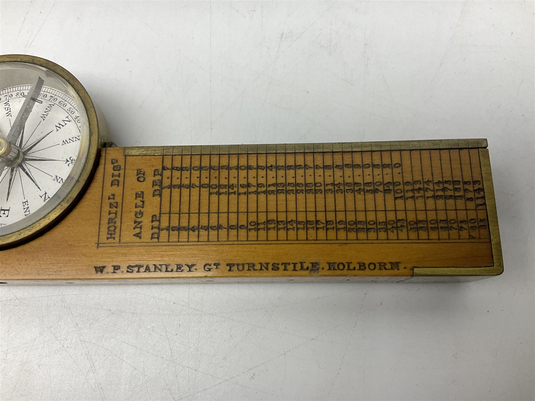 Late 19th/early 20th century boxwood and brass clinometer rule by Stanley, with inset magnetic compass, screw action protractor hinge divided to one degree with rise in inches per yard scale under, spirit level to one edge, marked 'W.F. Stanley Great Turnstile Holborn' with tables of distances, angles and thickness H16cm closed: in original leather covered case with instructions