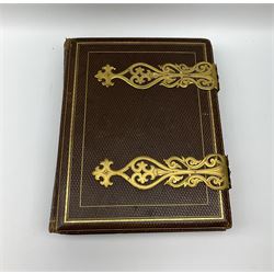 Victorian photo album with decorative metal clasps and embossed decoration, containing photographs, along with a selection of glass negative slides and lantern slides 