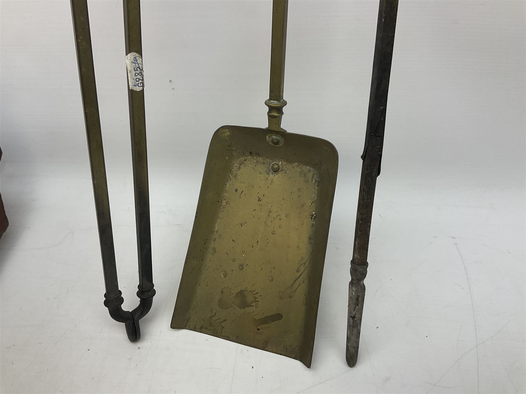 Victorian mahogany coal scuttle, the domed rolling lid carved with ornate foliate motifs opening to reveal interior with twin handled liner, mounted with carrying handle and shovel, together with brass fireside tools, largest H46cm