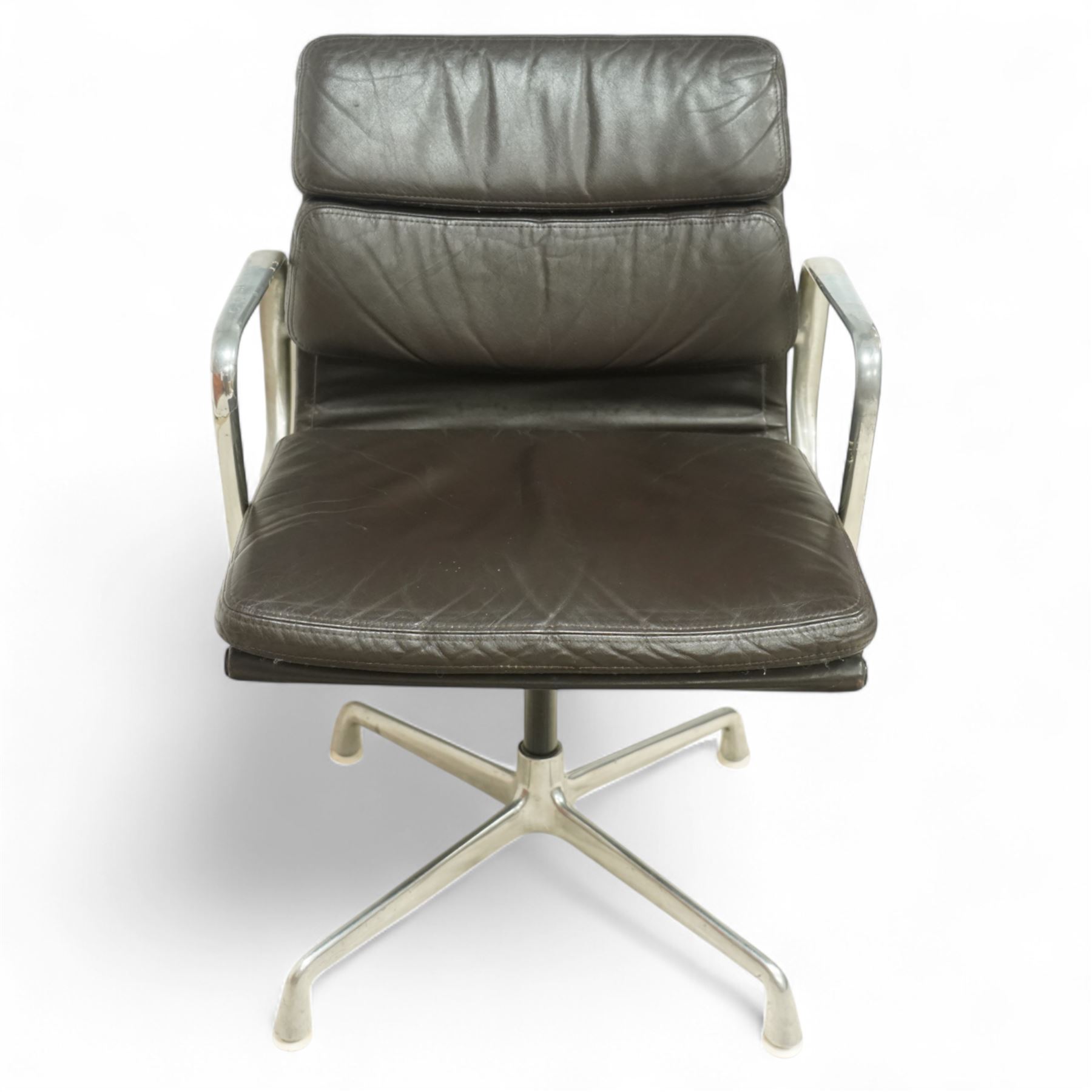 Charles and Ray Eames for Herman Miller - 1970s soft pad office chair model 'EA 207', low back and seat upholstered in chocolate brown leather flanked by open aluminium arms, raised on a non-swivelling aluminium base with manual screw adjustment function
