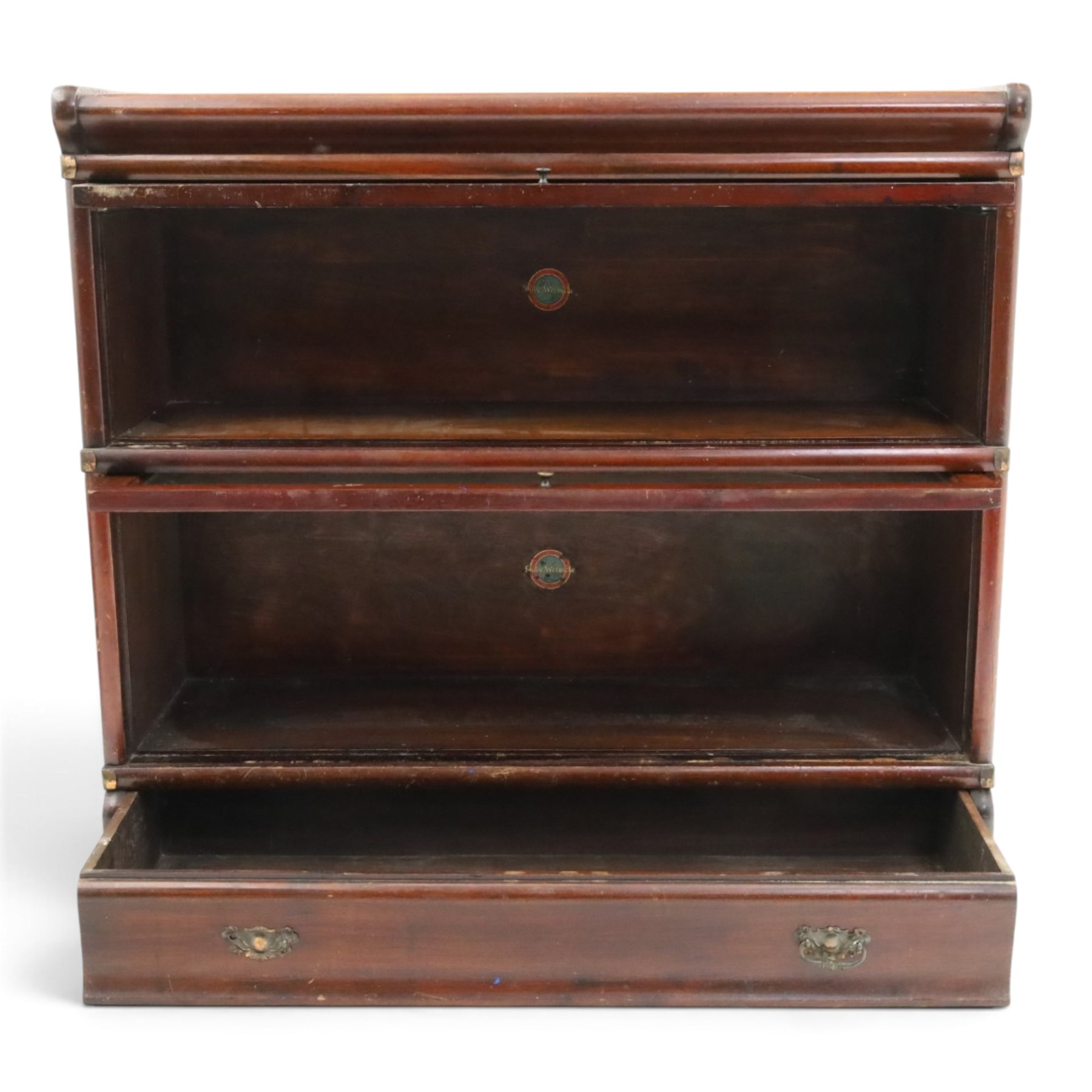 Globe Wernicke - early 20th century mahogany two-tier stacking library bookcase, fitted with glazed up-and-over doors, two drawers to the plinth base; together with a similar single-tier example (W87cm D27cm H54cm)