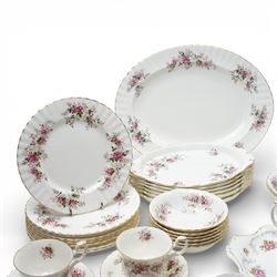 Royal Albert Lavender Rose tea and dinner wares, comprising eight dinner plates, and eight small dinner plates, eight side plates, open serving dish, teapot, open sucrier, salt and pepper, sandwich plate, sauce boat and saucer, eight teacups and saucers, six bowls, six oval serving dishes, and one platter