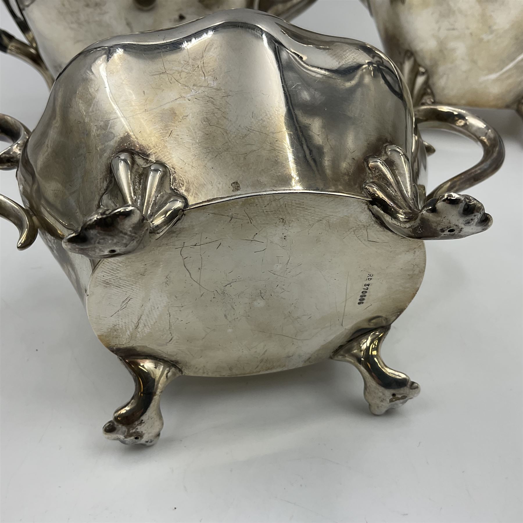 Five piece Edwardian silver tea service, comprising teapot and coffee pot, each with ebonised scroll handle, tea caddy with hinged cover, twin handled open sucrier, and milk jug, each of rounded bombe form, upon four paw feet, hallmarked William Adams Ltd, Birmingham 1904 and 1905, coffee pot H26cm
