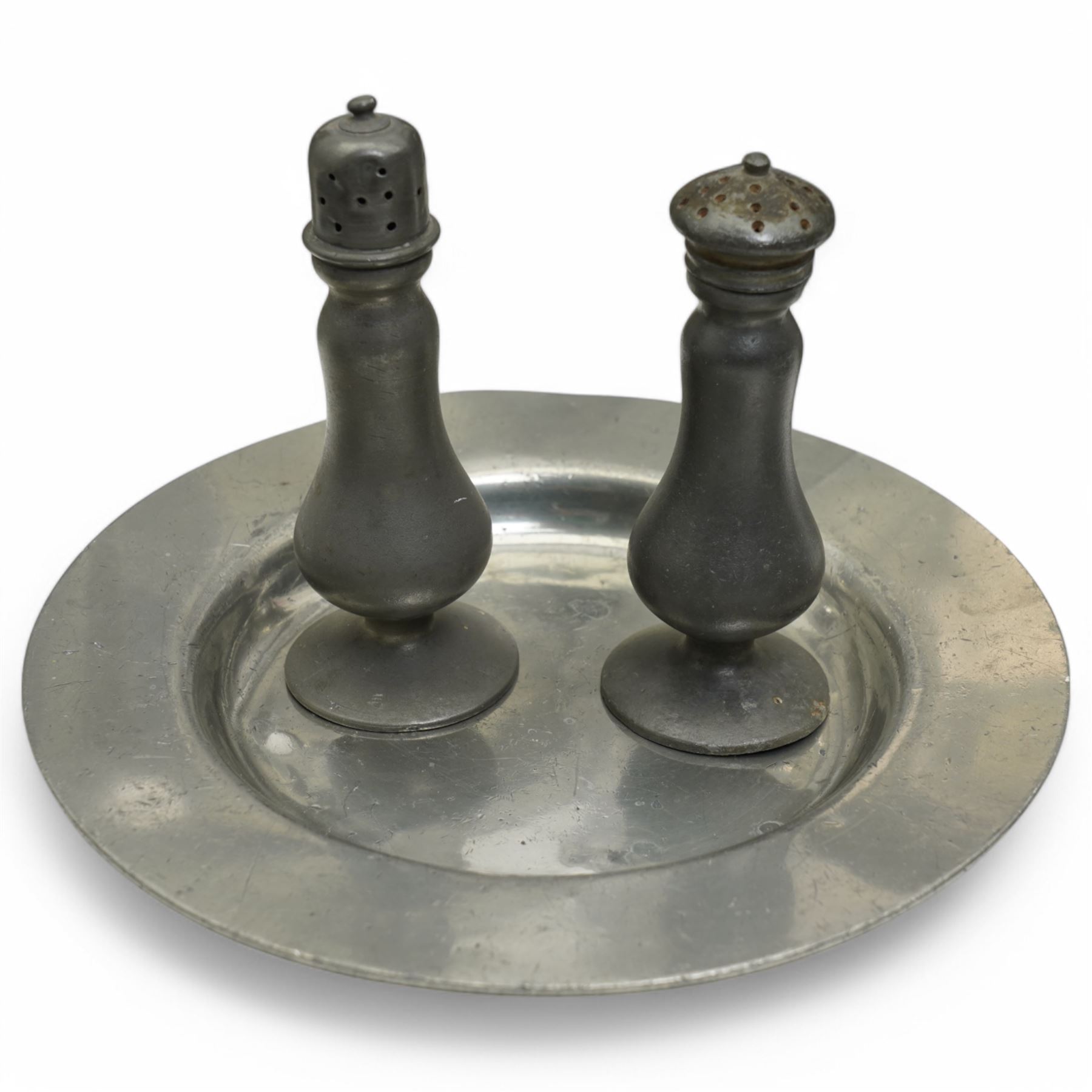 Collection of early 19th century and later British pewter, mostly London label marks, including two large pewter chargers, medicine spoon, flasks, plates and other tableware