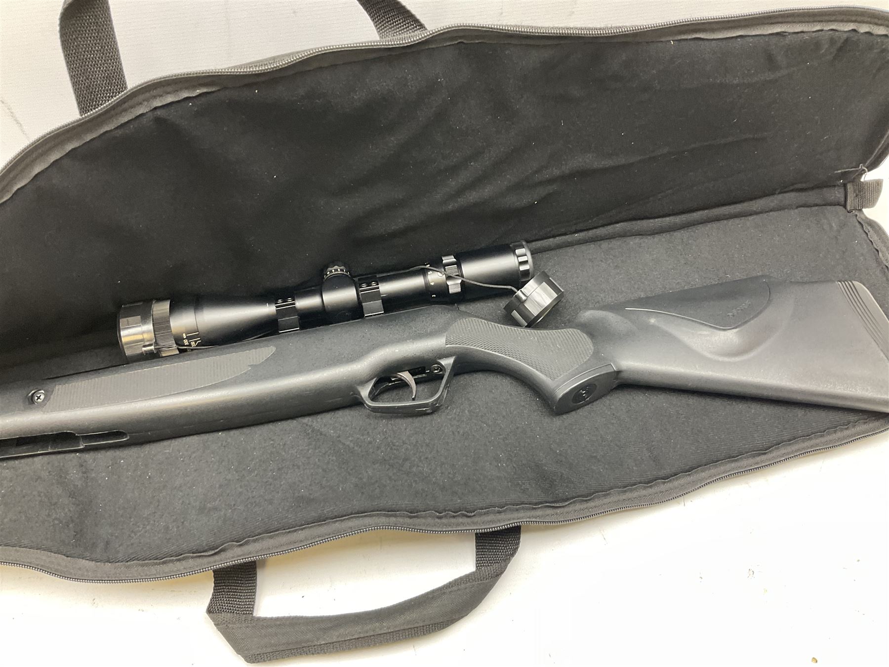 Stoegar .177 air rifle with break barrel action, 3 x 9 telescopic sight and fully integrated sound moderated barrel, no visible serial number, L109cm; in Stoeger lined gun sling
