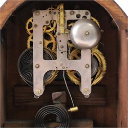 Gilbert Clock Company eight-day mahogany cased mantle clock, with a cream card dial, break arch top, upon a raised plinth, H28cm