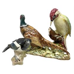 Three Beswick figures of birds, comprising pheasant no 1225, magpie no 2305 and woodpecker 1218, all with impressed marks beneath, tallest H22cm