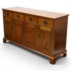 Acornman - mahogany sideboard, rectangular top over four drawers and four panelled cupboard doors with brass handles, on bracket feet, with signature carved acorn, by the workshop of Alan Grainger of Brandsby